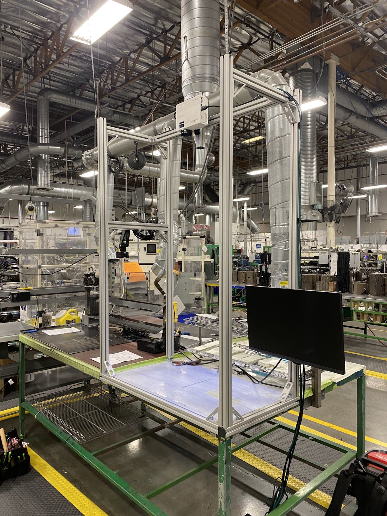 Factory-floor photo of the camera/projector rig
